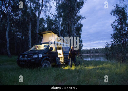 Woman photographer and campervan on the banks of the Murray River at Bourkes Bend Victoria Australia Stock Photo