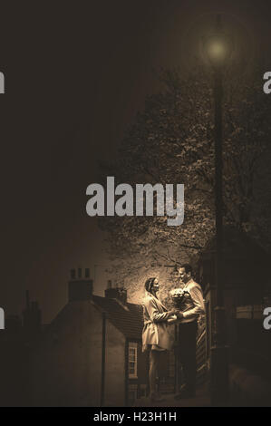 young couple standing on the bridge by the lamp post Stock Photo