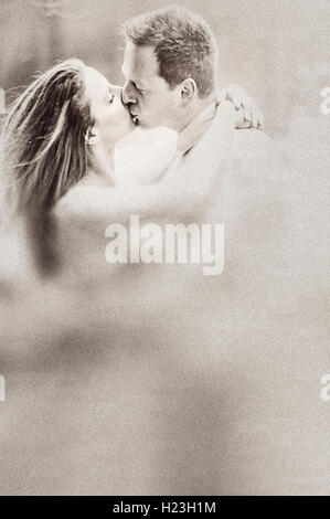 young woman and man kissing each other Stock Photo