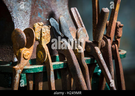 A set of metal workign tools in a forge or blacksmiths shop rusty with age. Stock Photo