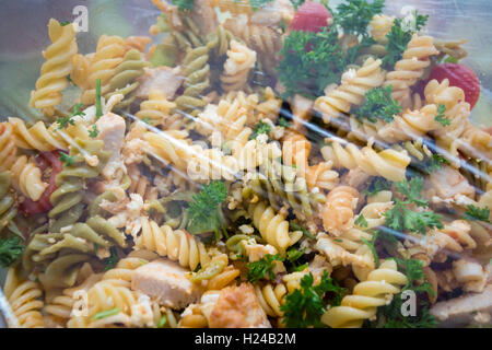 Bowls of salad and pasta covered in cling film protected from the flies adn from going off. Stock Photo