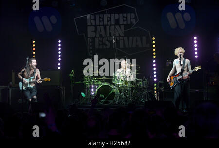 Hamburg, Germany. 24th Sep, 2016. The Scottish band Biffy Clyro with lead guitarist Simon Neil (L-R), drummer Ben Johnston and bassist James Johnston stands on stage at Docks during the Reeperbahn Festival in Hamburg, Germany, 24 September 2016. Photo: AXEL HEIMKEN/dpa/Alamy Live News Stock Photo