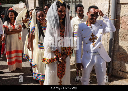 Jerusalem, Israel. 24th Sep, 2016. A bride and groom, in traditional ceremonious clothes, lead a wedding procession as Christian Africans, mostly from Ethiopia and Eritrea, converge for prayer on Saturdays, at the walled in Ethiopian Church compound, built in stages between 1874 and 1901. Credit:  Nir Alon/Alamy Live News Stock Photo