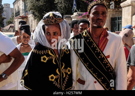 Jerusalem, Israel. 24th Sep, 2016. A bride and groom, in traditional ceremonious clothes, lead a wedding procession as Christian Africans, mostly from Ethiopia and Eritrea, converge for prayer on Saturdays, at the walled in Ethiopian Church compound, built in stages between 1874 and 1901. Credit:  Nir Alon/Alamy Live News Stock Photo
