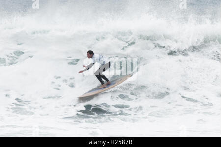 Epic white water huge wave being longboard surfed Fistral Bay UK Stock Photo