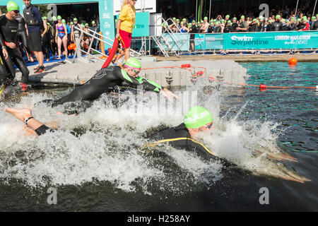 London, UK. 24 September 2016. Thousands of swimmers, most of them in wetsuits, take part in the first ever Swim Serpentine event in London's Hyde Park. Swimmers set off in waves of 350 and covered a distance of 1 mile. Credit:  Bettina Strenske/Alamy Live News