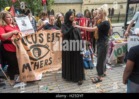 London, UK. 24th September 2016. A short rally at the end of the party by housing campaigners Focus E15 at the weekly street stall on Stratford Broadway celebrating the third anniversary of the fight against Newham Council is addressed by a woman who tells of the problem she has had in trying to see Newham Mayor Robin Wales - when she is always told 'next week'. Campaigners say that under his leadership Newham Council is deliberately leaving properties empty 'to rot in order to justify their demolition to make way for luxury apartments' which are being built on land which should be used for so Stock Photo