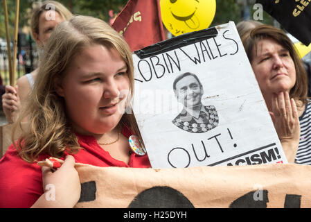 London, UK. 24th September 2016. Focus E15 housing campaigner Jasmin Stone holds a poster 'Robin Wales OUT!' at the rally at the end of their party at the weekly street stall on Stratford Broadway celebrating the third anniversary of the fight against Newham Council. Campaigners say that under his leadership as elected Mayor, Newham Council is deliberately leaving properties such as those on the Carpenters Estate empty 'to rot in order to justify their demolition to make way for luxury apartments' which are being built on land which should be used for social housing. Peter Marshall/Alamy Live  Stock Photo