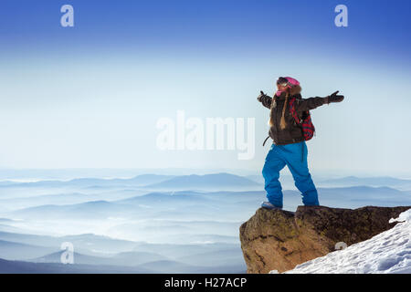 Snowboarder posing on blue sky backdrop in mountains skiing Stock Photo