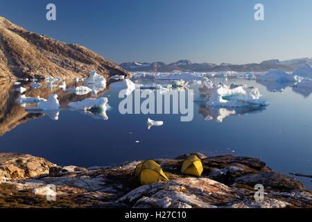 Icebergs and sea kayaker's camp on edge of Sermilik Fjord near settlement of Tiniteqilaq, East Greenland Stock Photo