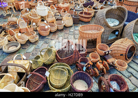 Straw baskets in different shapes and sizes on the display for sale at the Christmas Market in Riga, Latvia. At the market people can buy festive goods, souvenirs, traditional food and drinks. Stock Photo