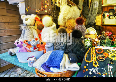 Riga, Latvia - December 25, 2015: Handmade animal toys, woolen hats and accessories displayed for sale at one of the stalls during the Christmas market in Riga, Latvia. Stock Photo