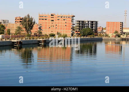 Unfinished houses along the banks of the Nile River in Esna, Egypt Stock Photo