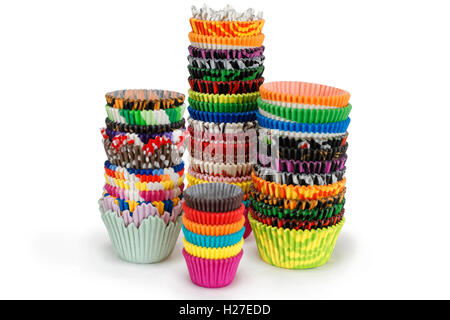 Bright multicolored Paper cupcake holders in a pile isolated on white background Stock Photo