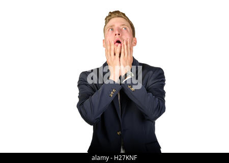 Young businessman dressed in a suit desperate look up isolated on white. Stock Photo