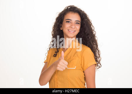 Happy young woman showing thumbs up Stock Photo