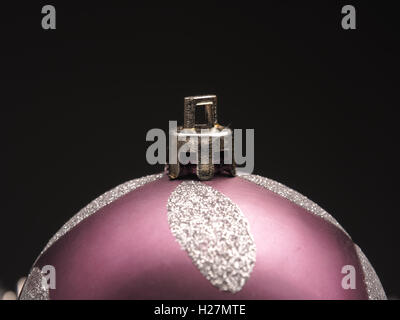 Closeup of a Christmas bauble on a dark background with space for text Stock Photo