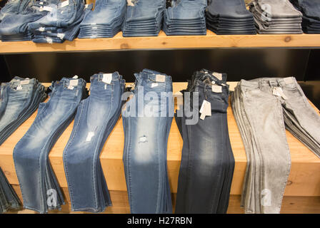 Store Display, Jeans Folded and Stacked on Tables Stock Photo