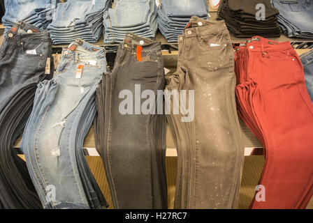 Store Display - Jeans Folded and Stacked on Table Stock Photo