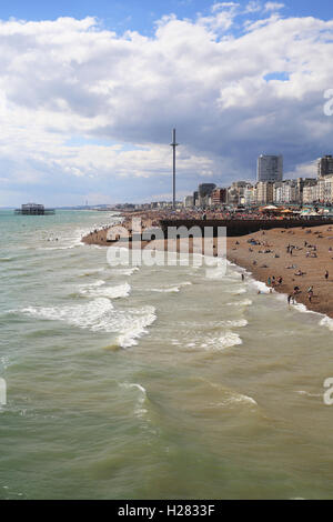 The view over Brighton beach from the Palace Pier, with the new i360 on the horizon, in East Sussex, England, UK Stock Photo