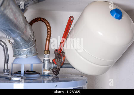 Maintenance on a hot water heater compression tank Stock Photo