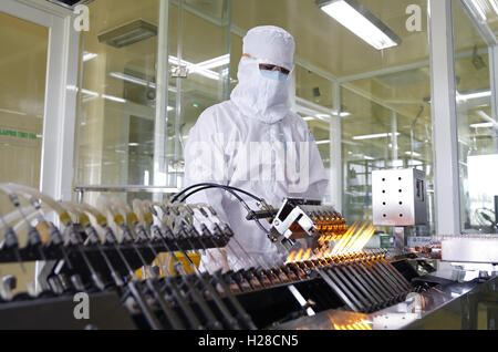Long An, Vietnam - January 7, 2016: Workers are working in a veterinary medicine lab to produce vaccine for animals Stock Photo