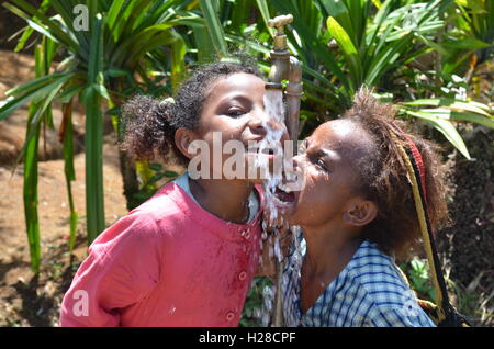 Papua New Guinea - October 25, 2015: Children are happy with water in a remote and difficult place in Papua New Guinea Stock Photo