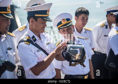 Vietnam Peoples Navy sailors examine a breathing mask during a training event for Naval Engagement Activity Vietnam aboard the USN Arleigh Burke-class guided-missile destroyer USS Fitzgerald April 7, 2015 in Da Nang, Vietnam. Stock Photo