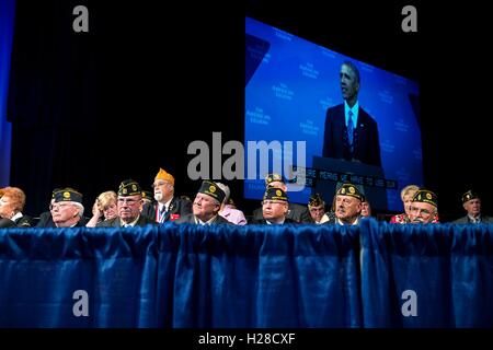 A group of veterans watch as U.S. President Barack Obama delivers a speech during the American Legions 96th National Convention at the Charlotte Convention Center August 26, 2014 in Charlotte, North Carolina. Stock Photo