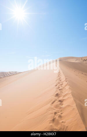 cenic ridges of sand dunes with footprints in Sossusvlei, Namib Naukluft National Park, best tourist and travel attraction in Na Stock Photo