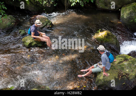 Indonesia, Bali, Tampaksiring, Gunung Kawi Temple complex, tourists cooling feet in Pakerisan River Stock Photo