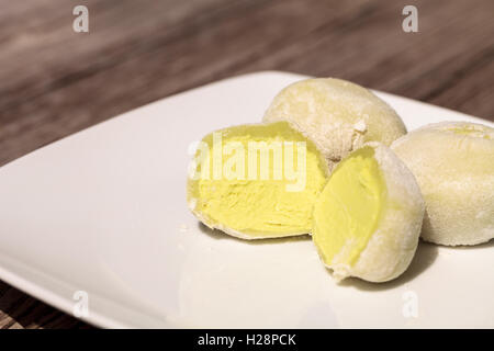Green tea mochi ice cream bonbon desert on a white plate Stock Photo