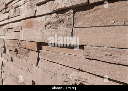 closely stacked dry stone wall slate quartz layers of stone showing texture Stock Photo