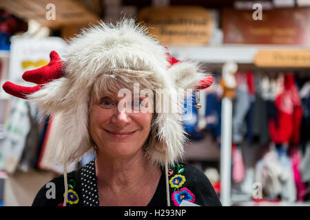 Norway, Bergen. Bryggen, historic waterfront area, circa 12th century, UNECSO World Heritage Site. Shopping area, happy tourist Stock Photo