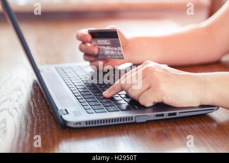 Hands holding credit card and using laptop - online shopping Stock Photo