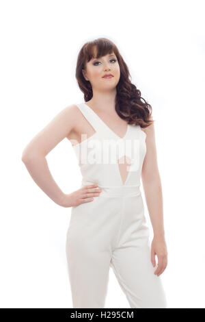 Auburn brunette english rose female portrait, wearing white jumpsuit, white background Stock Photo