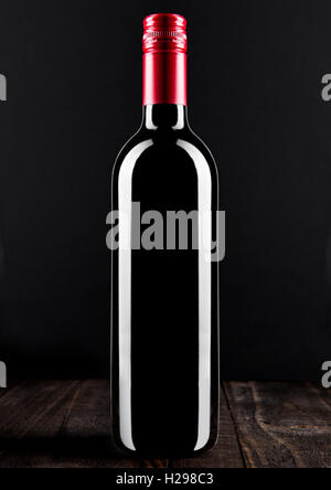 Red wine bottle  on wooden table black background Stock Photo