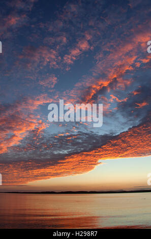 Isle of Gigha, Scotland. Picturesque sunset over the Sound of Gigha, with the Isle of Gigha in the background. Stock Photo