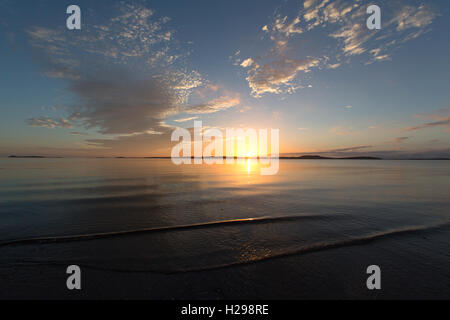 Isle of Gigha, Scotland. Picturesque sunset over the Sound of Gigha, with the Isle of Gigha in the background. Stock Photo