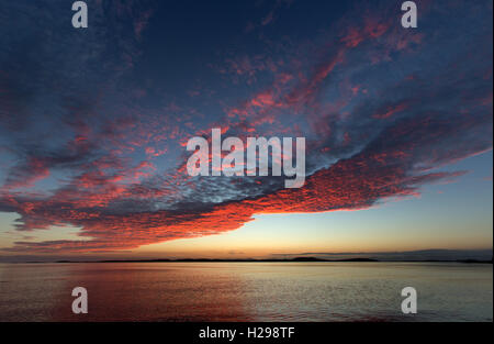 Isle of Gigha, Scotland. Picturesque sunset over the Sound of Gigha, with the Isle of Gigha in the background. Stock Photo