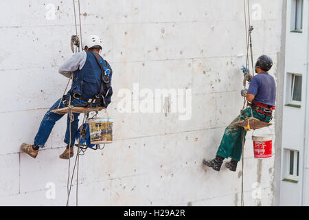 Skilled workers working in a house wall. Stock Photo