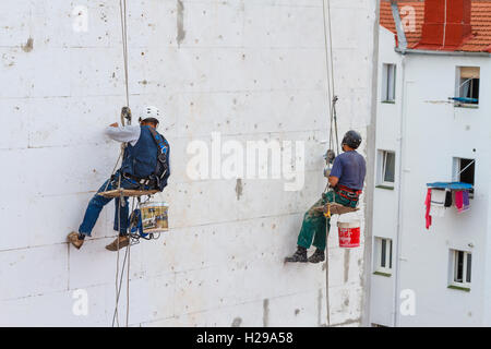 Skilled workers working in a house wall. Stock Photo