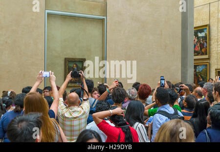 Mona Lisa. Crowd of visitors trying to photograph the Mona Lisa by Leonardo da Vinci, Musee du Louvre, Paris, France Stock Photo
