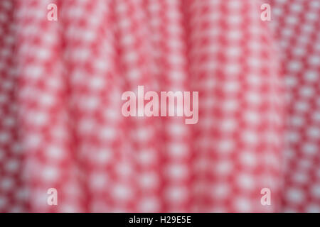 Abstract out of focus red-white polka dot cotton material. Concept 'International Dot Day', dotty person. Stock Photo