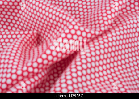 Abstract out of focus red-white polka dot material. Concept 'International Dot Day' and perhaps a dotty personality, dotty person. Stock Photo