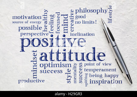 positive attitude word cloud - handwriting on a white lokta paper wit a pen Stock Photo
