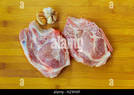 fresh meat : raw uncooked fat lamb pork rib and fillet with green stuff and red chili pepper on wooden plate isolated over white Stock Photo