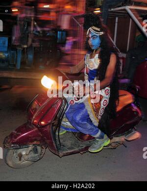 Allahabad, Uttar Pradesh, India. 26th Sep, 2016. Allahabad: An Artist dressed as Lord Shiva drive scooty ahead of a religious procession Ravan ki Barat in Allahabad on September 26, 2016, held to mark the Dussehra festival. The name Dussehra is derived from Sanskrit Dasha-hara literally means removal of ten referring to Lord Rama's victory over the ten-headed demon king Ravana. Dussehra is celebrated on the tenth day of the month of Ashwin according to the Hindu calendar which corresponds to September or October of the Gregorian calendar. (Credit Image: © Prabhat Kumar Verma via ZUMA Wir Stock Photo