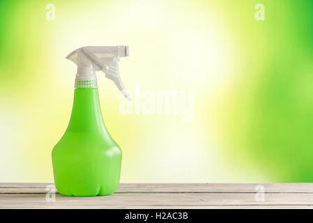 Spray can on a wooden table with a green background Stock Photo