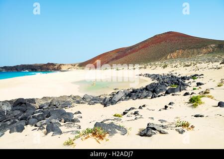 Lanzarote, Canary Islands. Along beach of Playa de las Conchas on Isla Graciosa, Lanzarote, to volcanic cone of Montana Bermeja Stock Photo